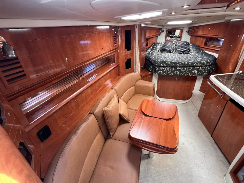 Slide: The Image of Luxurious 2006 Four Winns 348 Vista yacht interior with elegant wood finish and cozy seating. - 2