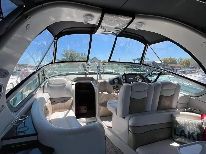 Slide: The Image of 2006 Four Winns 348 Vista boat interior with plush seating and modern dashboard. - 20