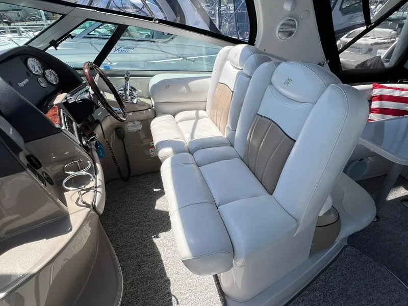 Slide: The Image of 2006 Four Winns 348 Vista boat interior with white leather seating and dashboard. - 21