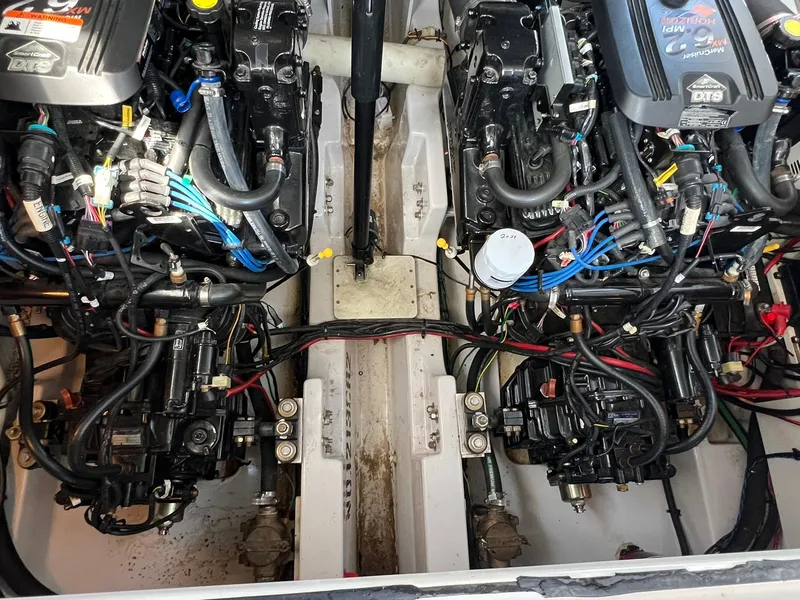 Slide: The Image of Engine compartment of a 2006 Four Winns 348 Vista boat, showcasing dual engines and wiring. - 28