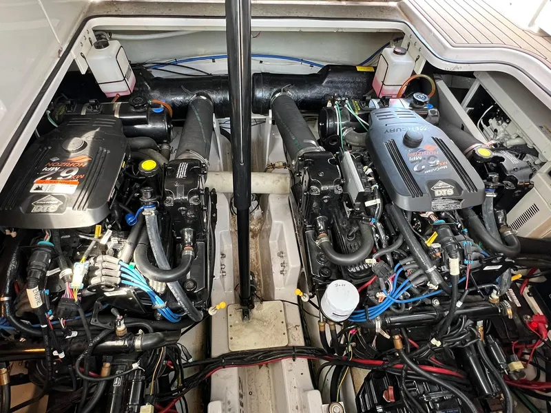 Slide: The Image of Engine compartment of a 2006 Four Winns 348 Vista boat, showcasing dual engines and components. - 29