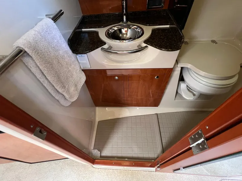 Slide: The Image of 2006 Four Winns 348 Vista bathroom with sink, toilet, and towel rack. - 6