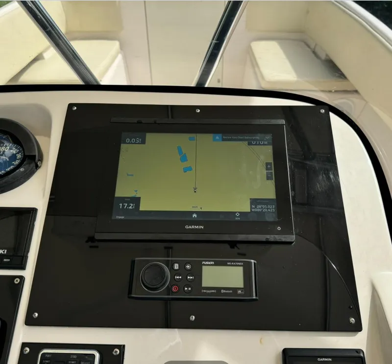 Slide: The Image of 2001 Intrepid 327 Center Console dashboard with Garmin navigation display. - 10