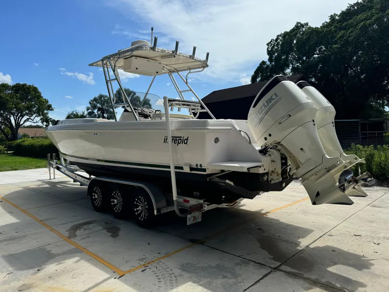 Slide: The Image of 2001 Intrepid 327 Center Console boat on trailer, parked outdoors. - 11