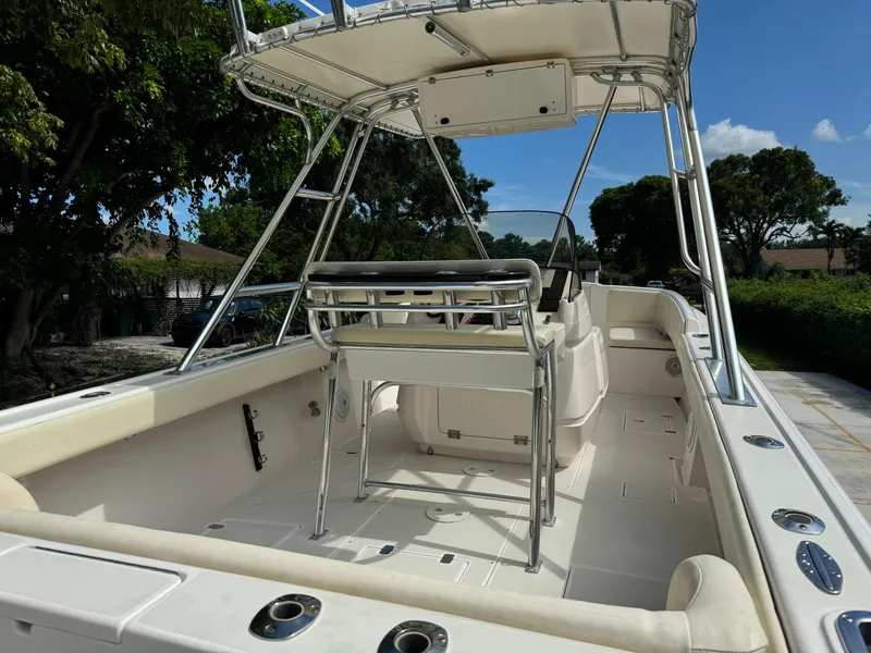 Slide: The Image of 2001 Intrepid 327 Center Console boat with spacious deck and seating, under clear blue sky. - 14