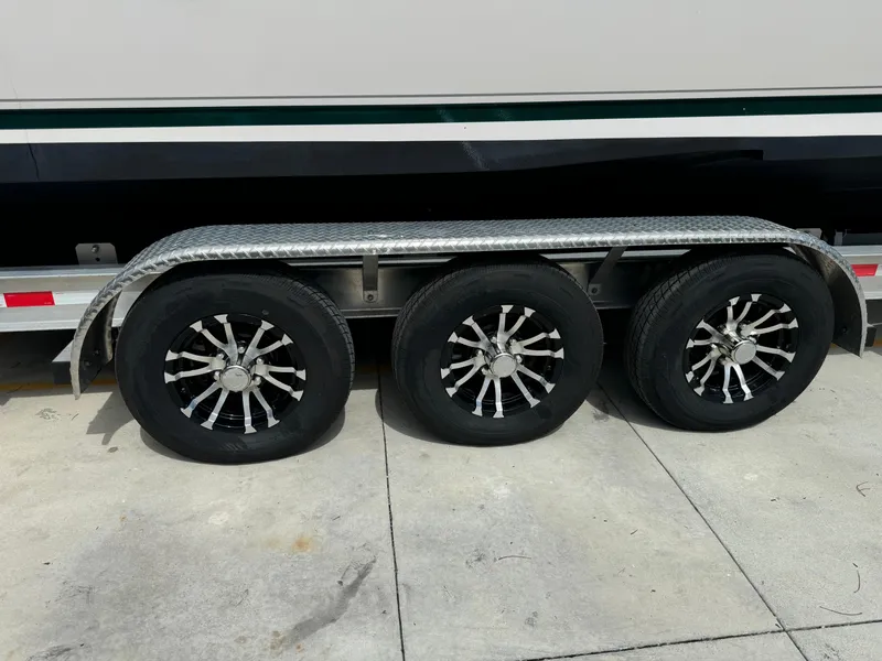 Slide: The Image of Triple-axle trailer with black alloy wheels for 2001 Intrepid 327 Center Console boat. - 15