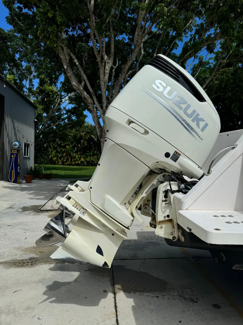 Slide: The Image of 2001 Intrepid 327 Center Console with Suzuki outboard motor, parked outdoors. - 16