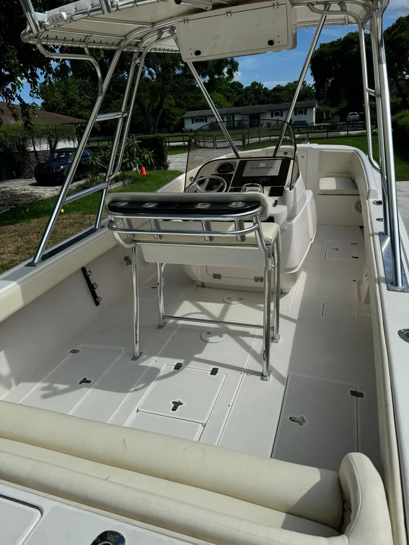 Slide: The Image of 2001 Intrepid 327 Center Console boat interior with helm and seating, showcasing spacious deck layout. - 17