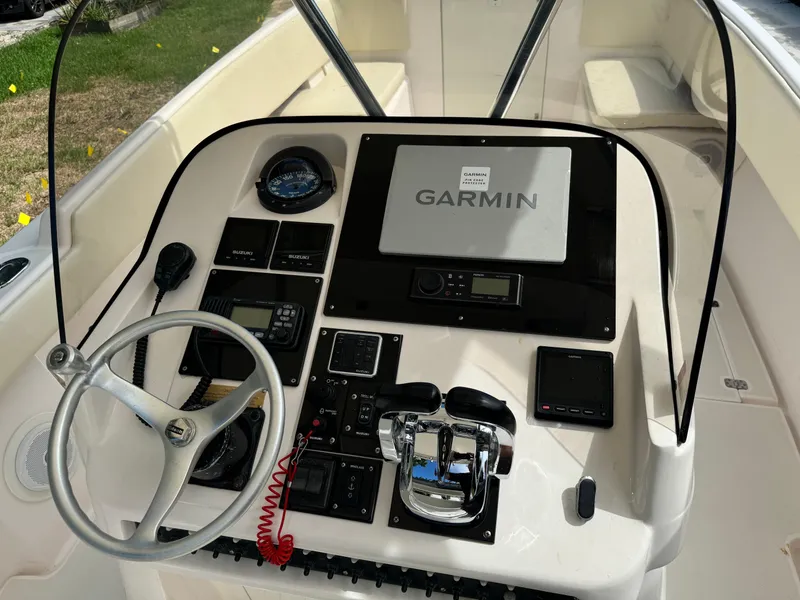 Slide: The Image of 2001 Intrepid 327 Center Console boat dashboard with Garmin navigation system. - 19