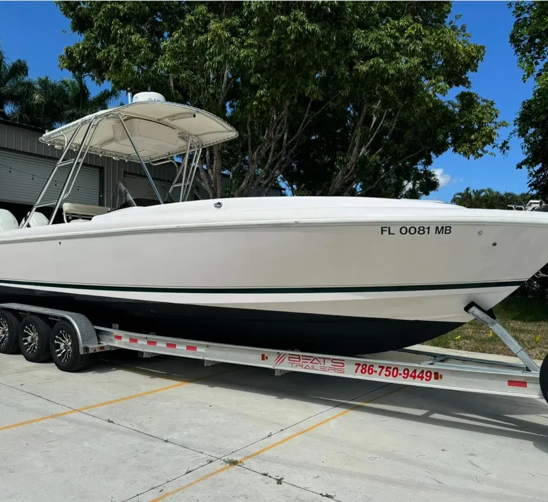 Slide: The Image of 2001 Intrepid 327 Center Console boat on trailer, parked outdoors. - 2
