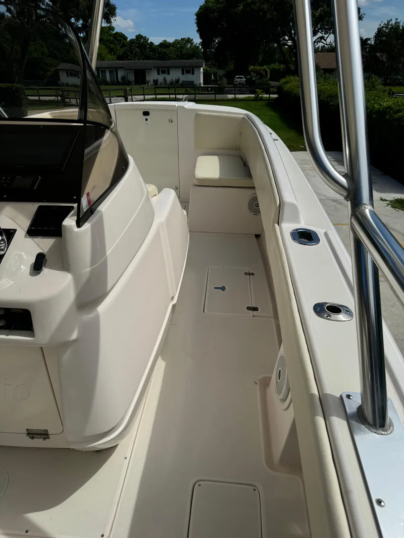 Slide: The Image of 2001 Intrepid 327 Center Console boat interior with seating and control panel. - 22