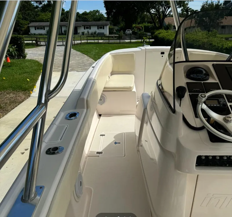 Slide: The Image of 2001 Intrepid 327 Center Console boat interior with steering wheel and seating. - 8