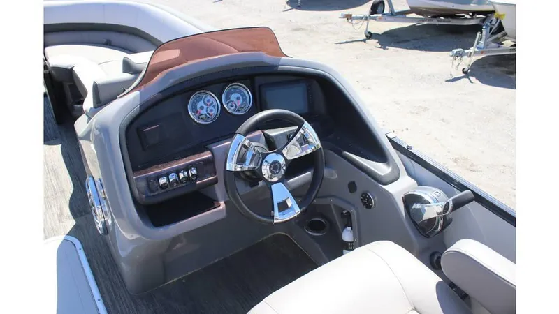 Slide: The Image of 2022 Avalon Catalina Quad Lounger dashboard with steering wheel and gauges. - 4