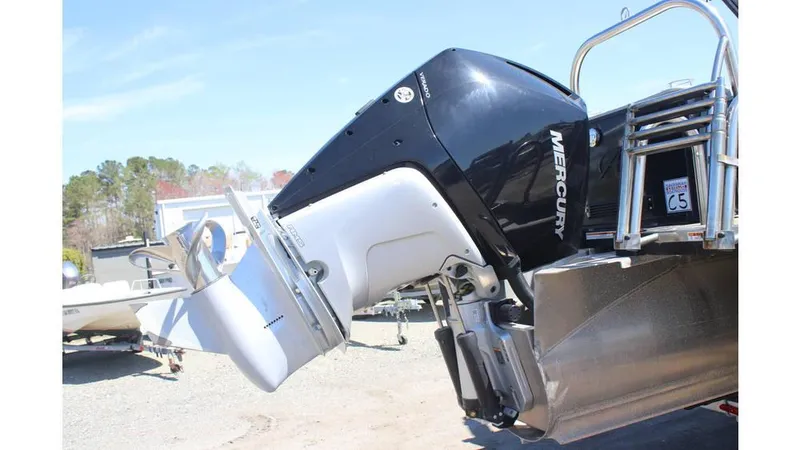 Slide: The Image of 2022 Avalon Catalina Quad Lounger with Mercury outboard motor, parked on a trailer. - 5