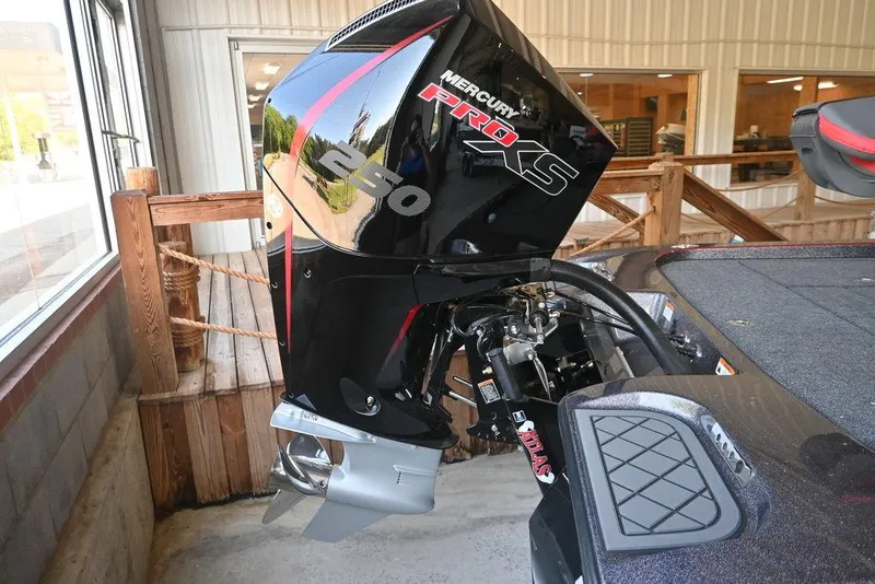 Slide: The Image of 2025 Caymas CX 20 PRO with Mercury Pro XS engine, displayed indoors. - 2