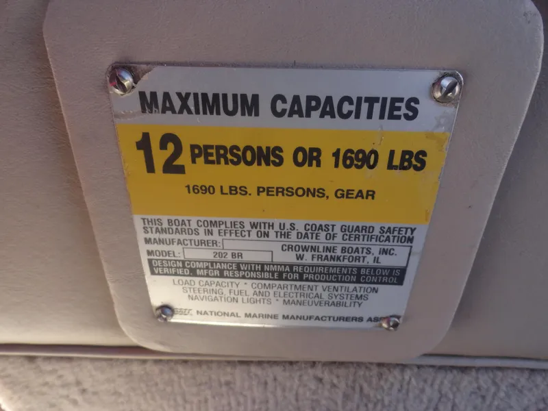 Slide: The Image of Maximum capacity label on 2001 Crownline 202 BR LPX boat, 12 persons or 1690 lbs. - 13