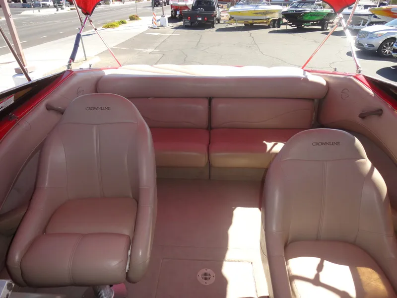 Slide: The Image of Interior of 2001 Crownline 202 BR LPX boat with beige seating and red accents. - 16