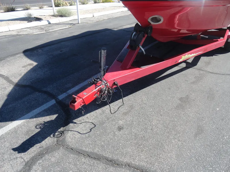 Slide: The Image of Red 2001 Crownline 202 BR LPX boat trailer parked on asphalt. - 19