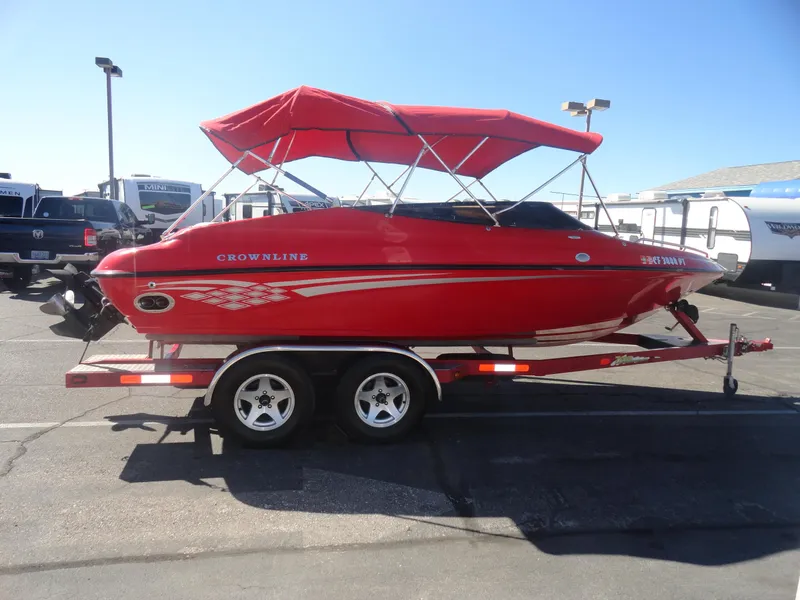 Slide: The Image of Red 2001 Crownline 202 BR LPX boat with canopy on trailer in parking lot. - 5