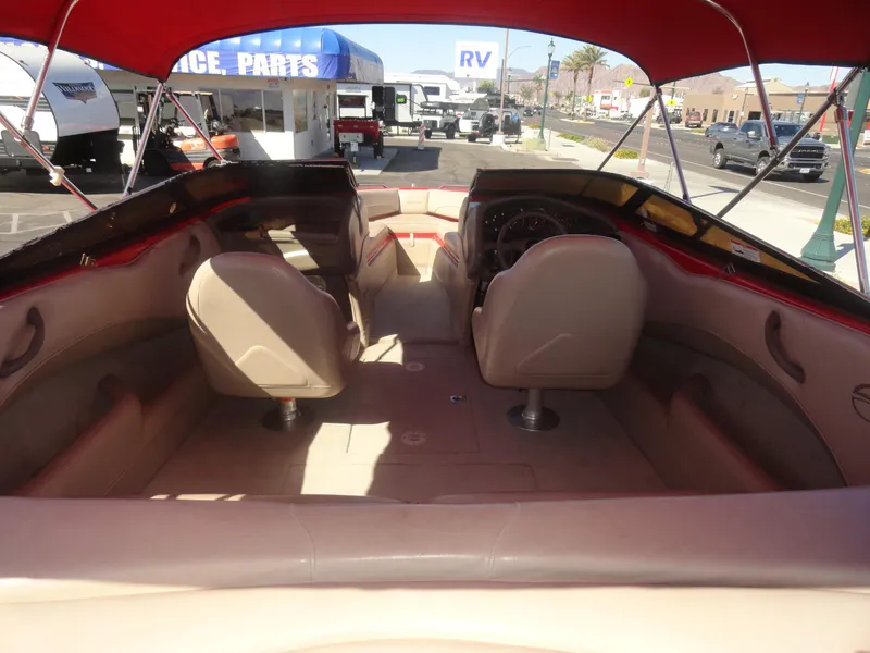 Slide: The Image of Interior view of 2001 Crownline 202 BR LPX boat with red canopy and beige seating. - 6