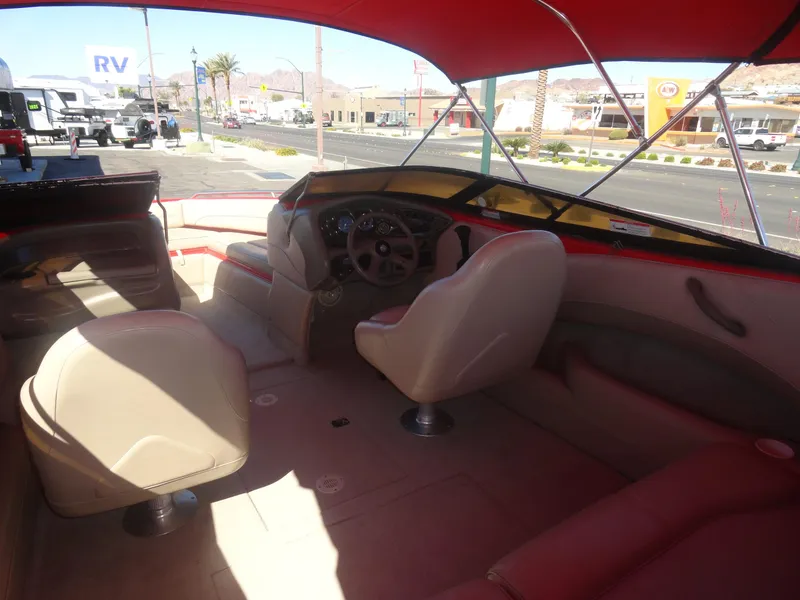 Slide: The Image of Interior of 2001 Crownline 202 BR LPX boat with beige seating and red canopy. - 7
