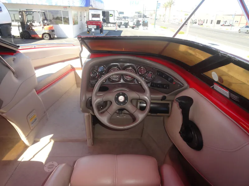 Slide: The Image of 2001 Crownline 202 BR LPX boat interior with steering wheel and dashboard controls. - 8