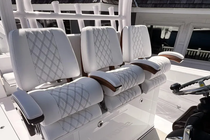 Slide: The Image of 2025 Sportsman Open 352 Center Console boat seats with diamond stitching and armrests. - 9