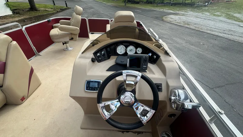 Slide: The Image of 2014 Harris Cruiser 240 boat dashboard with steering wheel and control panel. - 6