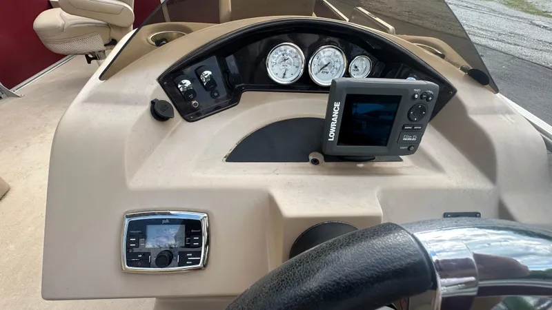 Slide: The Image of Dashboard of 2014 Harris Cruiser 240 boat with gauges and Lowrance display. - 7