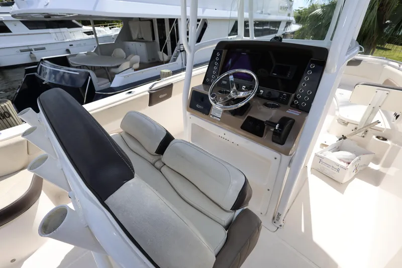 Slide: The Image of 2019 Robalo R242 Explorer boat cockpit with steering wheel and seating. - 10