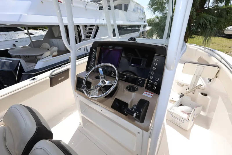 Slide: The Image of 2019 Robalo R242 Explorer boat helm with steering wheel and control panel. - 11