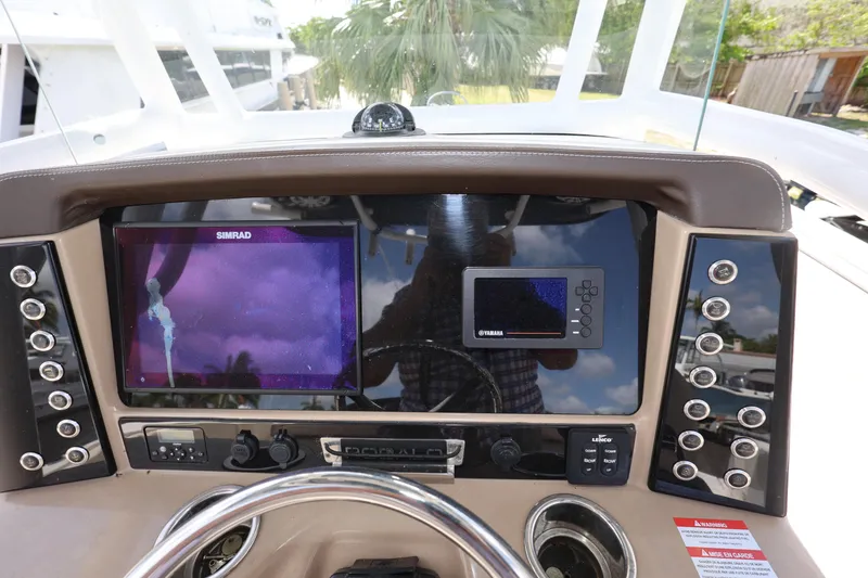 Slide: The Image of 2019 Robalo R242 Explorer dashboard with navigation and control panels. - 13