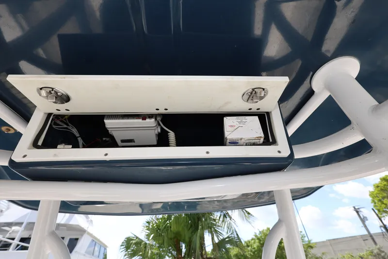 Slide: The Image of 2019 Robalo R242 Explorer boat electronics compartment with open panel. - 14