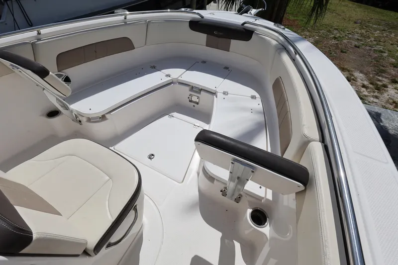 Slide: The Image of 2019 Robalo R242 Explorer boat interior with cushioned seating and storage compartments. - 16