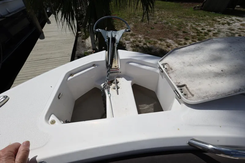 Slide: The Image of 2019 Robalo R242 Explorer boat anchor compartment with open hatch. - 17