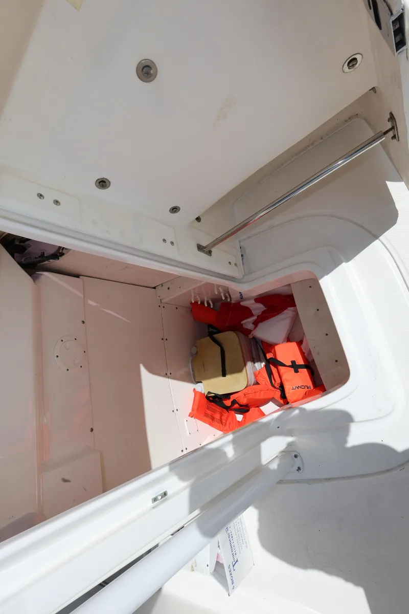 Slide: The Image of Storage compartment in 2019 Robalo R242 Explorer boat with life jackets. - 20