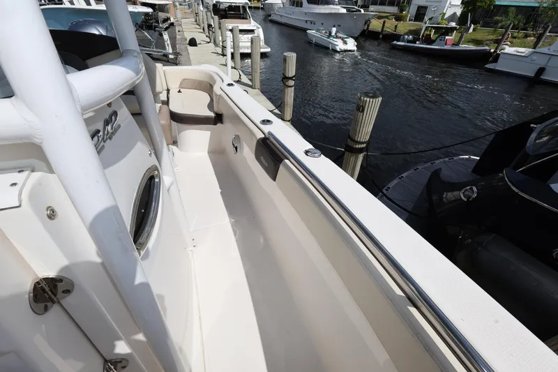 Slide: The Image of 2019 Robalo R242 Explorer boat docked at marina, side view. - 21