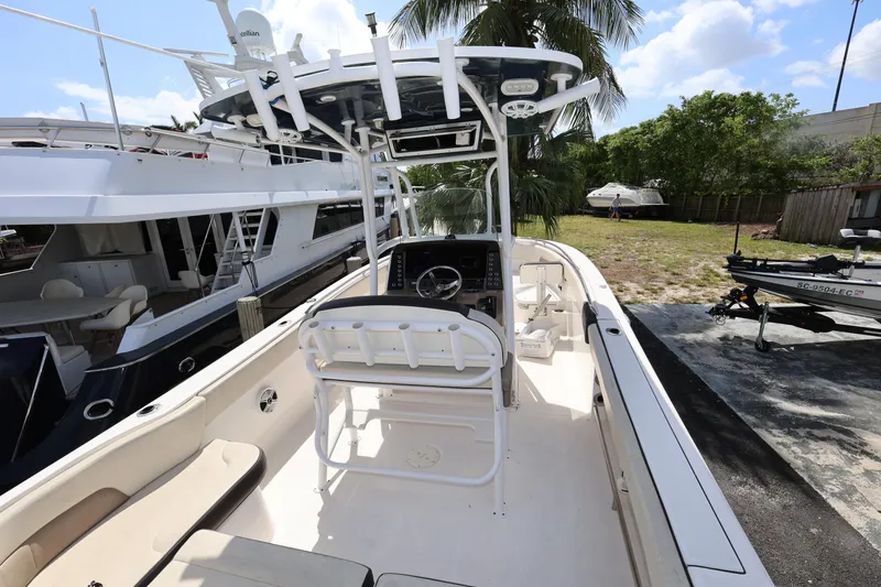 Slide: The Image of 2019 Robalo R242 Explorer boat with center console and seating, docked outdoors. - 8