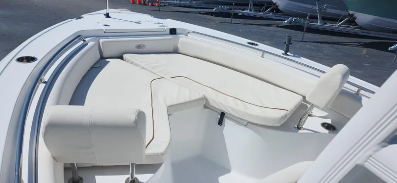 Slide: The Image of 2022 Sea Hunt Ultra 234 boat with white cushioned seating area. - 3
