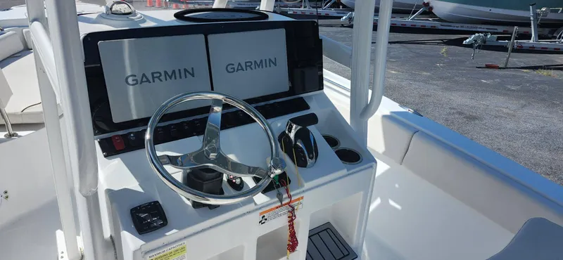 Slide: The Image of 2022 Sea Hunt Ultra 234 boat console with dual Garmin displays and steering wheel. - 4