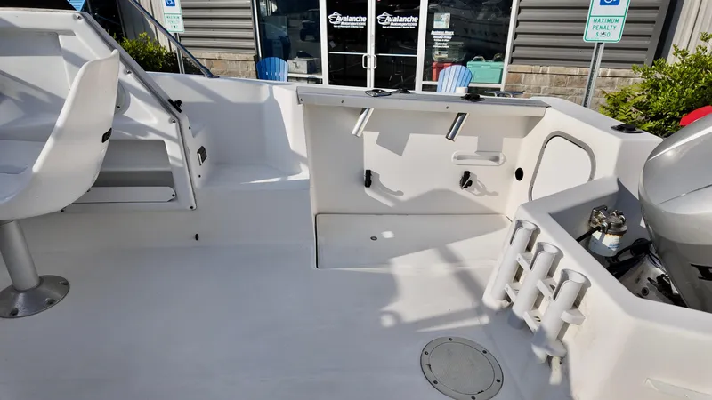 Slide: The Image of 1998 Bayliner Trophy 1802 Cuddy boat interior with seating and rod holders. - 10