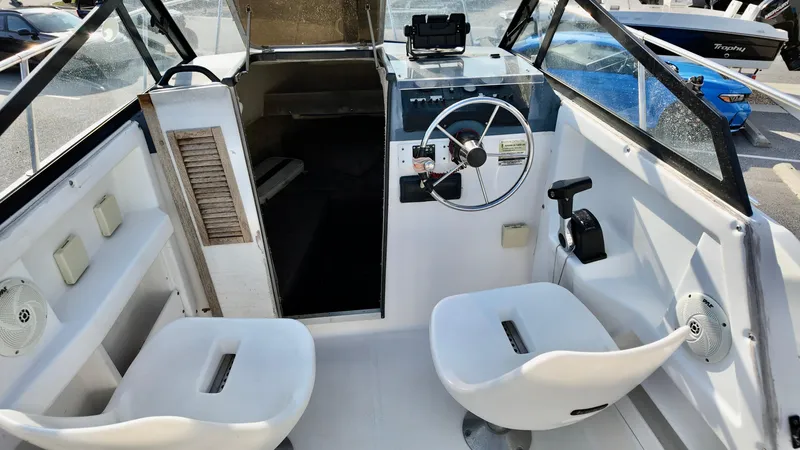 Slide: The Image of 1998 Bayliner Trophy 1802 Cuddy boat interior with steering wheel and seating. - 13