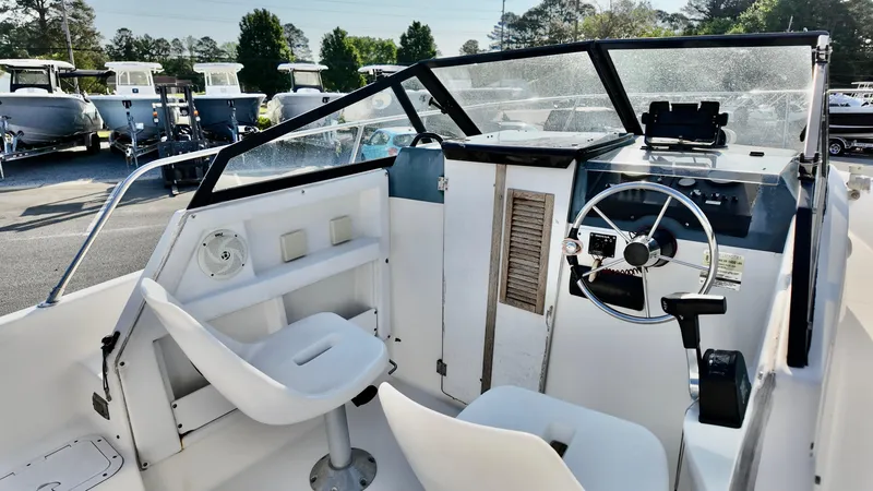 Slide: The Image of 1998 Bayliner Trophy 1802 Cuddy boat interior with steering wheel and seating. - 5