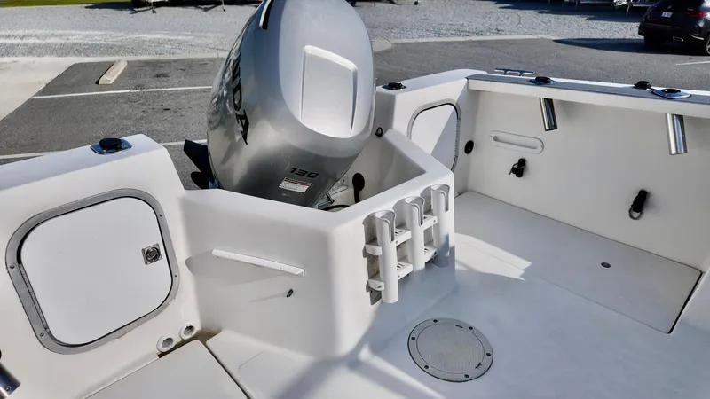 Slide: The Image of 1998 Bayliner Trophy 1802 Cuddy boat interior with motor and rod holders. - 6