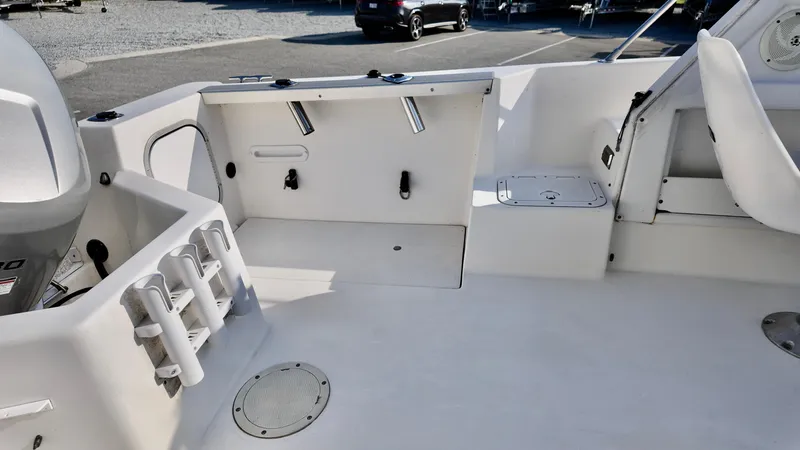 Slide: The Image of 1998 Bayliner Trophy 1802 Cuddy boat interior with rod holders and storage compartments. - 7