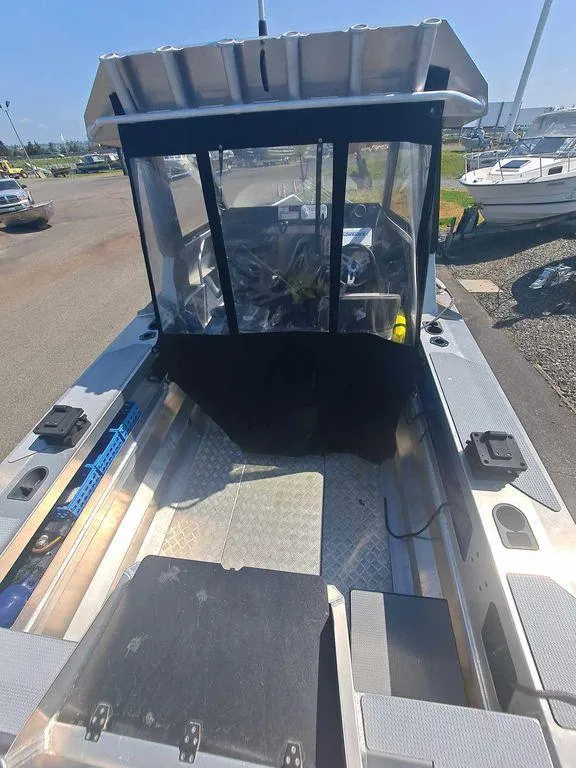 Slide: The Image of 2021 Stabicraft 1850 Supercab X1 boat with spacious deck and cabin, docked outdoors. - 1