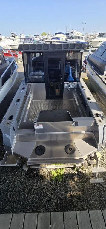 Slide: The Image of 2021 Stabicraft 1850 Supercab X1 boat docked, rear view, in a marina setting. - 6