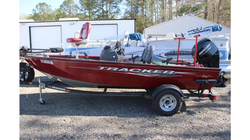 Slide: The Image of 2021 Tracker Super Guide V-16 SC fishing boat on trailer, parked outdoors. - 4
