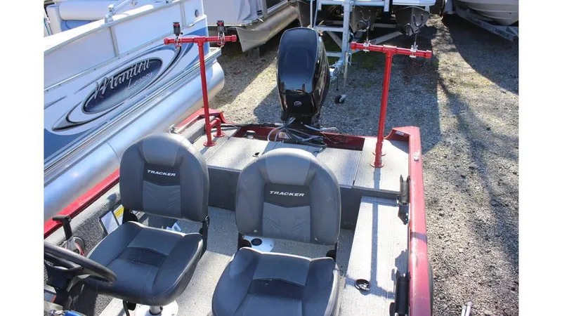 Slide: The Image of 2021 Tracker Super Guide V-16 SC boat with dual seats and motor, parked outdoors. - 5