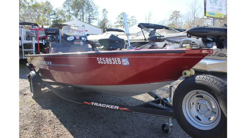 Slide: The Image of 2021 Tracker Super Guide V-16 SC boat on trailer, red exterior, parked outdoors. - 6